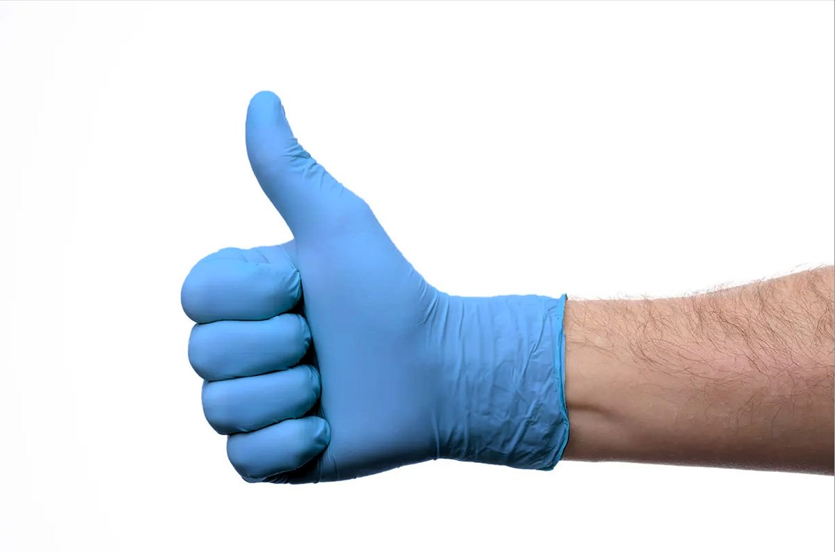 Blue powder-free nitrile examination glove worn on a hand