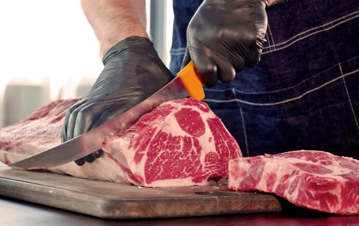 Food safe black prosenso gloves cutting ribeye steak
