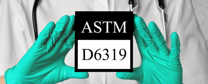 Green gloves holding ASTM D6319 logo