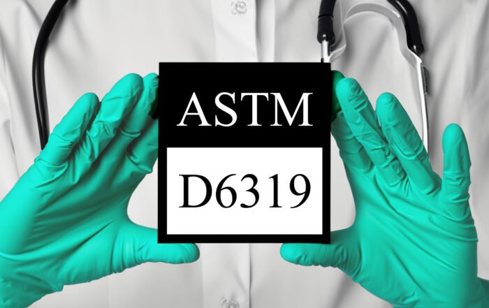 Green gloves holding ASTM D6319 logo